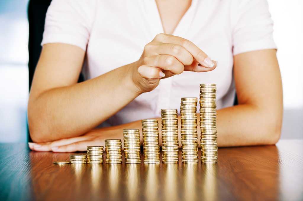 A woman stacking gold coins.