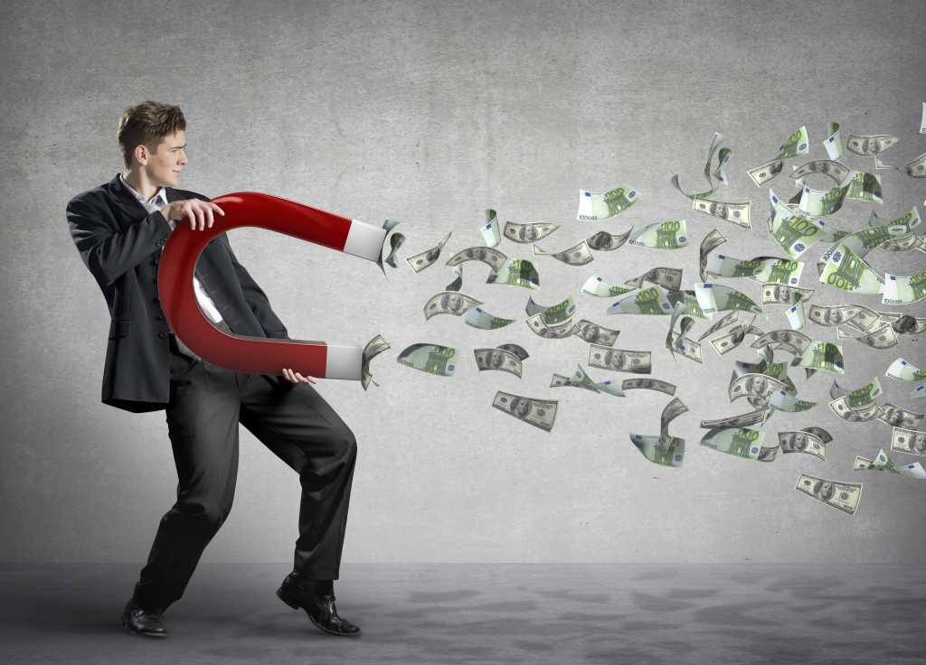 Businessman attracts money with a large magnet 164176162