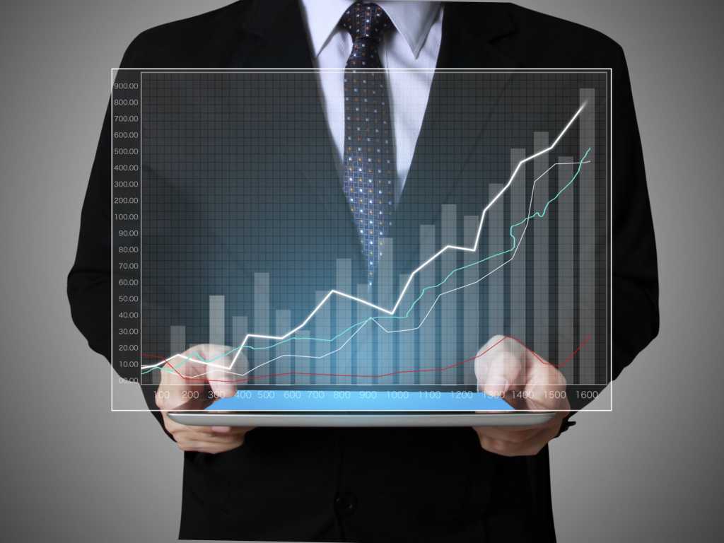 Hand touch screen graph on a tablet chart data businessman