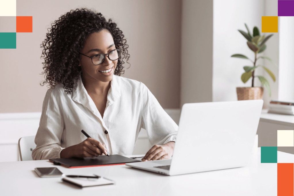 Smiling woman looking at laptop