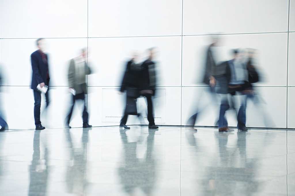 business commuters walking along corridor blurred motion 154002438