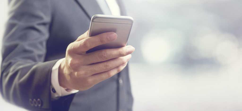 Close focus shot of a businessman using a mobile phone