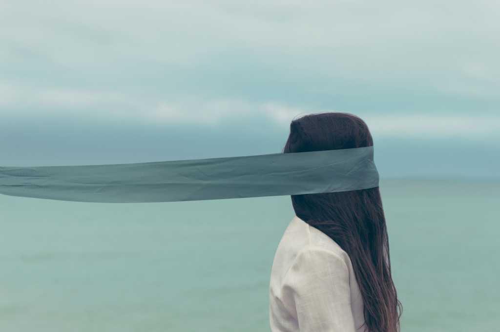 business woman wearing blindfold [by Oscar Keys - CC0 via Unsplash]