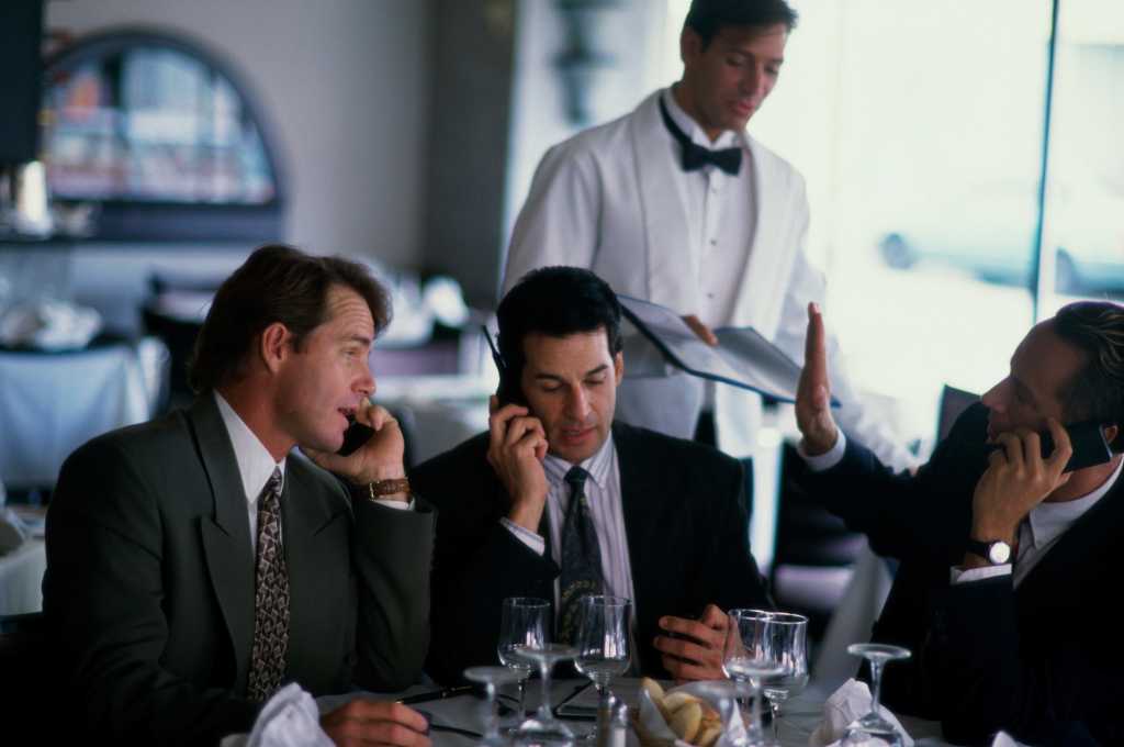 businessman on cellphones during meal 122412895