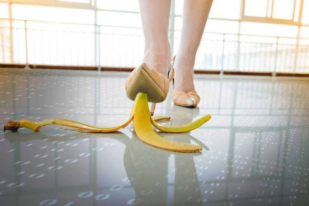 A woman is about to step on a banana peel on a binary floor. / risks / mistakes / vulnerabilities