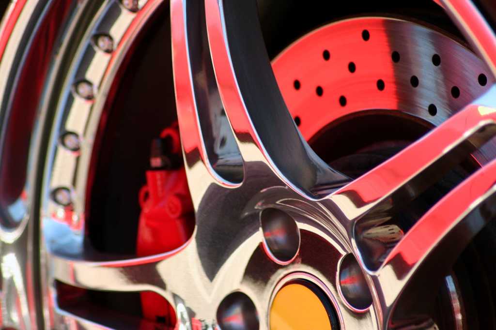 chrome hubcap / red wheel reflection