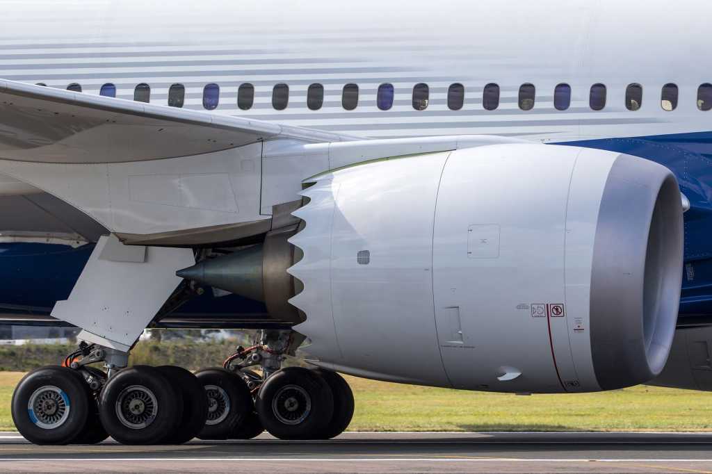A Boeing 787 Dreamliner Aircraft side on [image show wheels down on runway]