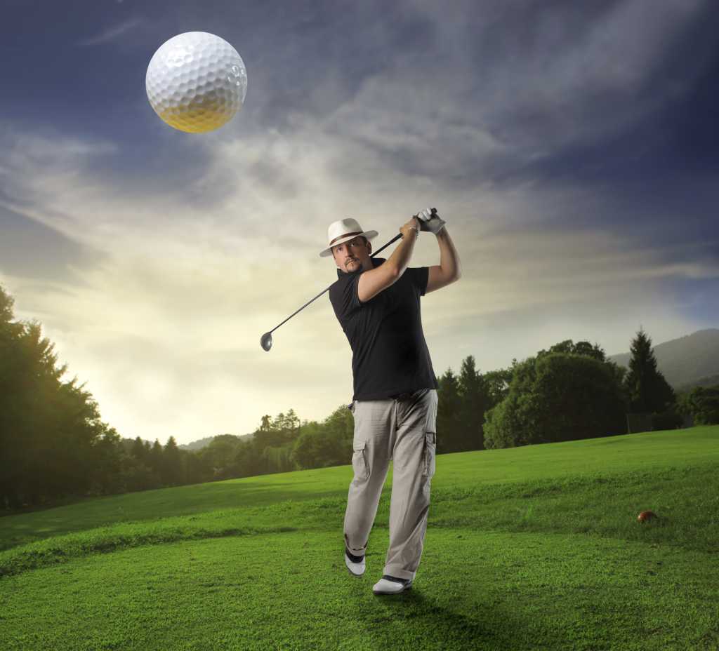 closeup of airborn golfball and golfer 98174551