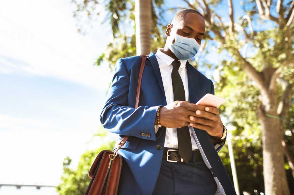 diversity coronavirus mask return to the workplace post covid mobile businessman by franckreporter