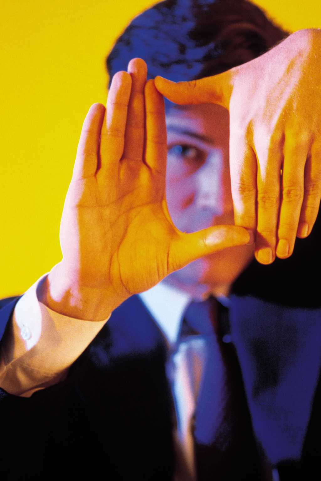 Man framing with hands in front of face to focus