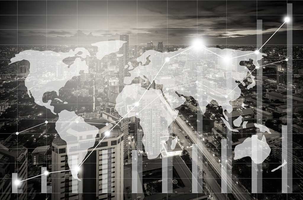 mutiple-exposure image of a world map, charts and graphs, and an aerial view of a city