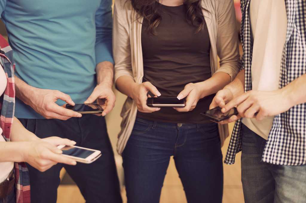 friends using iphone smartphones mobile facebook app