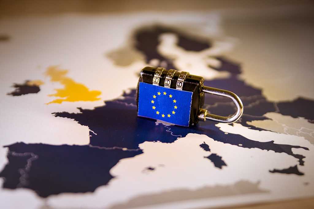 European Union [EU] flag-lock on top of a map of Europe