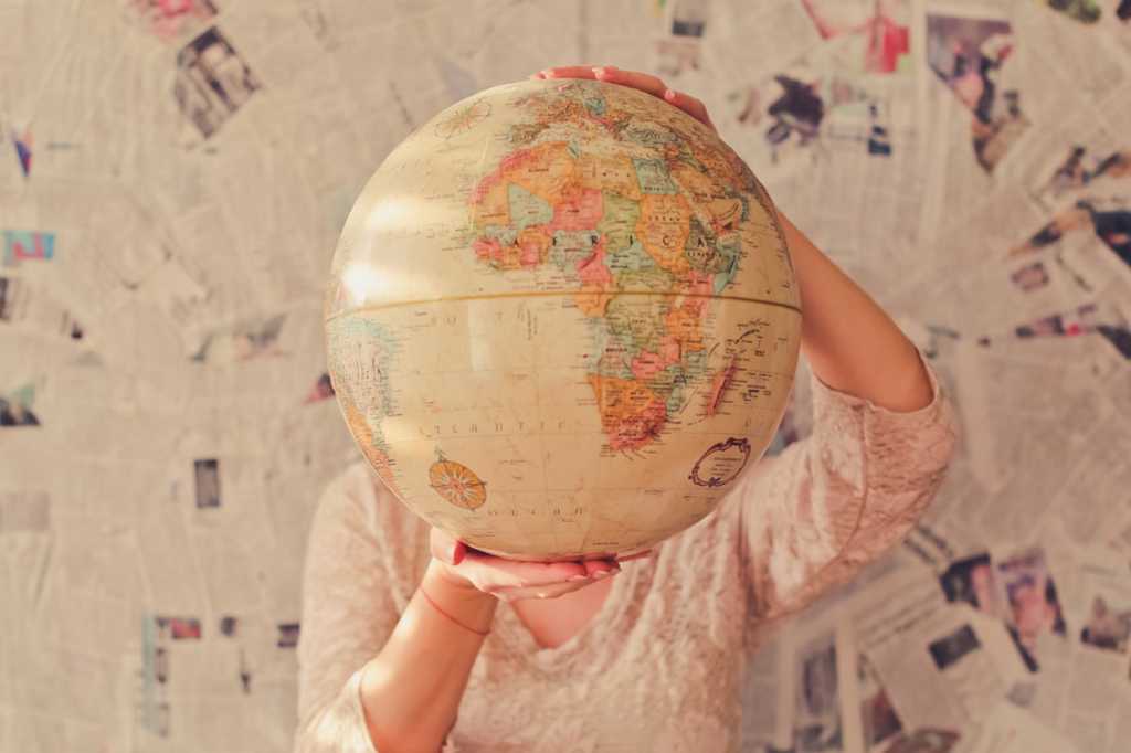 globe map outsourcing international travel slava bowman unsplash