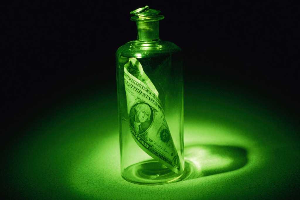 green bottle with money inside save message in a bottle