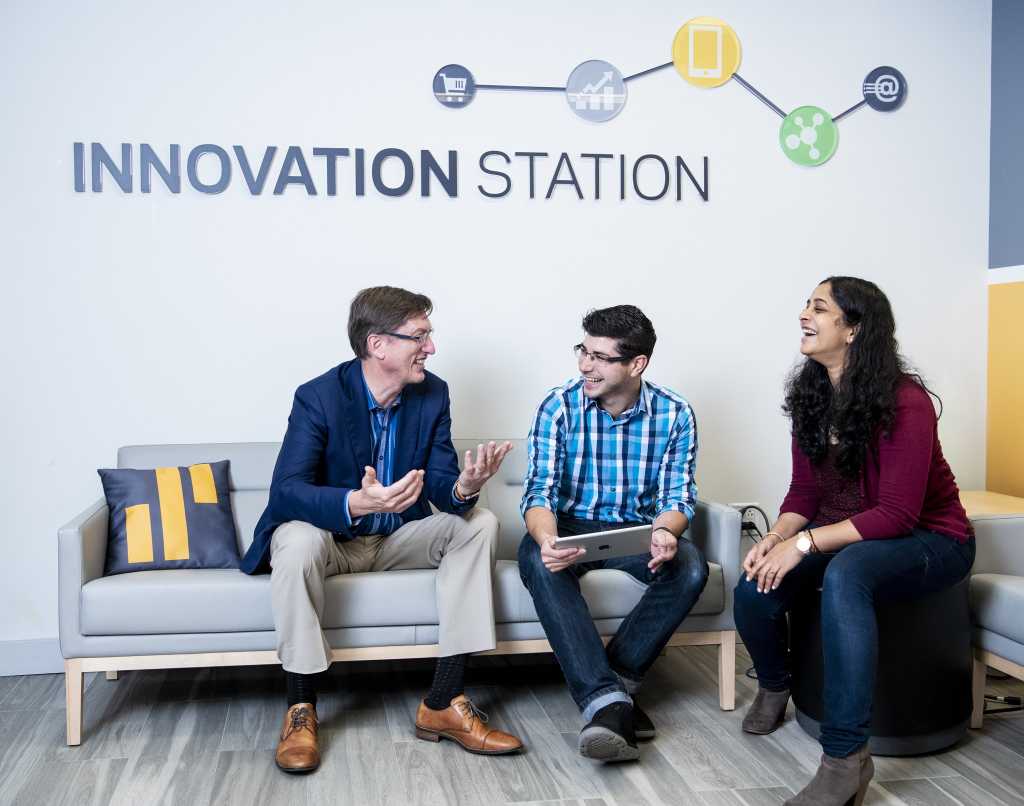 Greg Simpson and others discussing at the Innovation Station