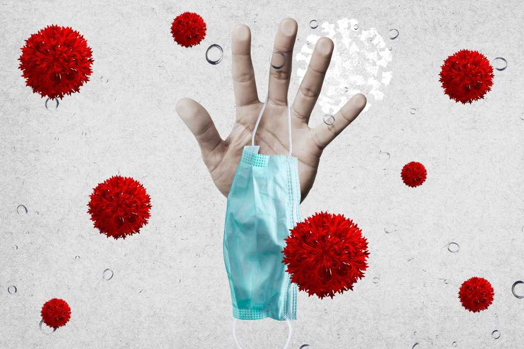 A hand holds a face mask, surrounded by virus morphology.