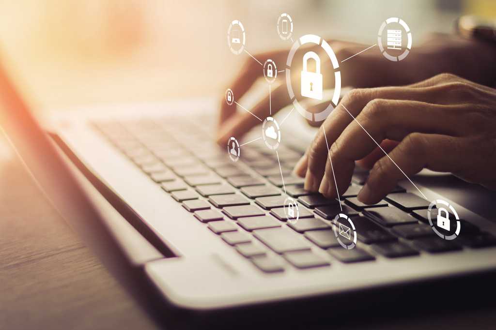 Secure network devices and services overlay on hands using a laptop keyboard.