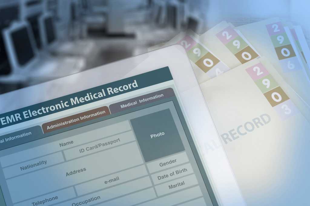 Background photo showing medical record changing from paperwork to electronic medical record. stock photo