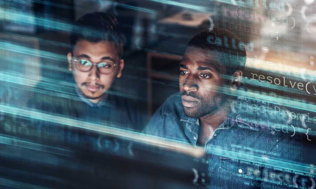 two handsome businessmen working in the office superimposed over multiple lines of computer code stock photo