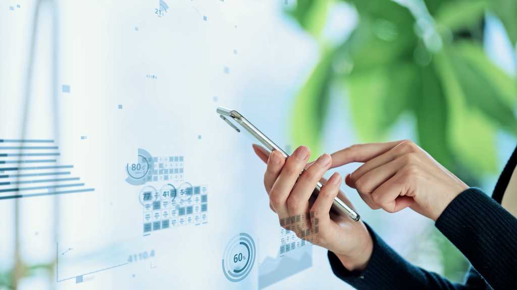 Data analysis concept. Financial technology. Mobile app. Hand holding phone.