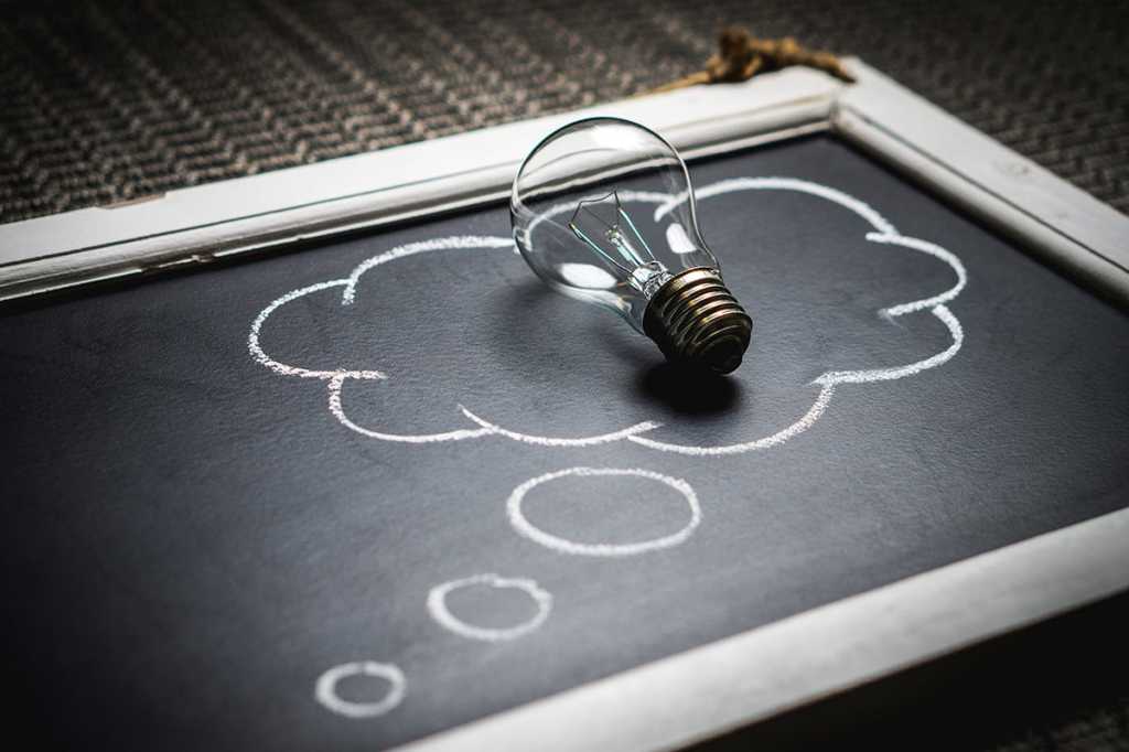 lightbulb on chalkboard / idea / innovation / imagination / invention / education / brainstorm