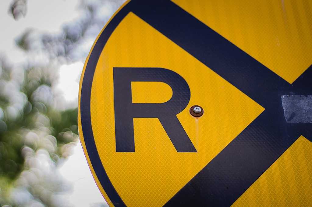 The letter 'R' on a railroad caution sign.