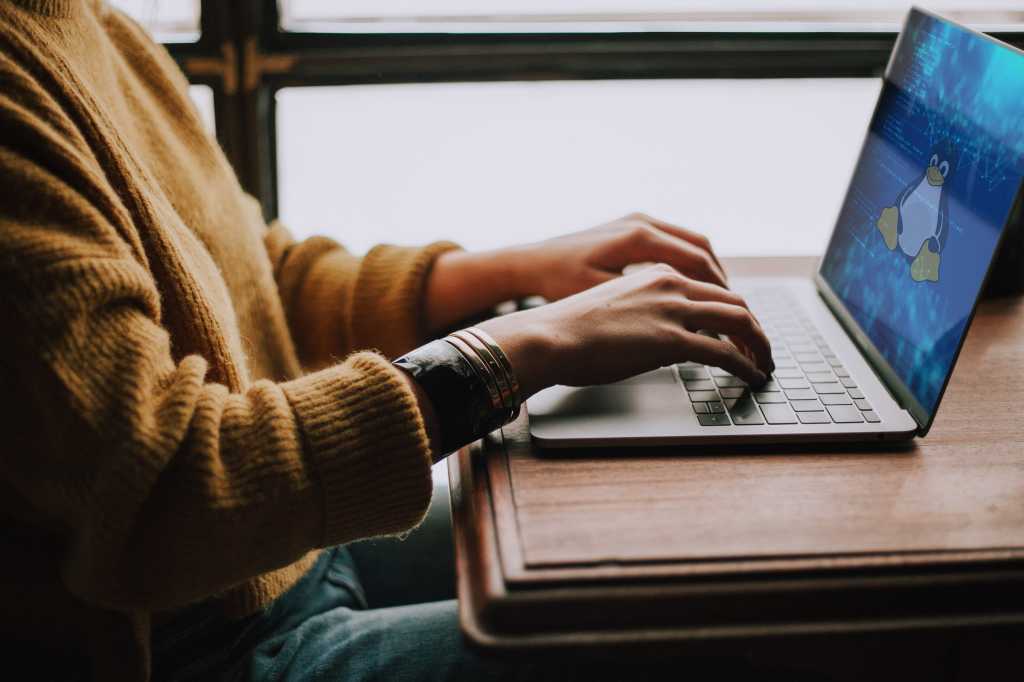linux woman with laptop keyboard code programmer devops by christin hume via unsplash linux