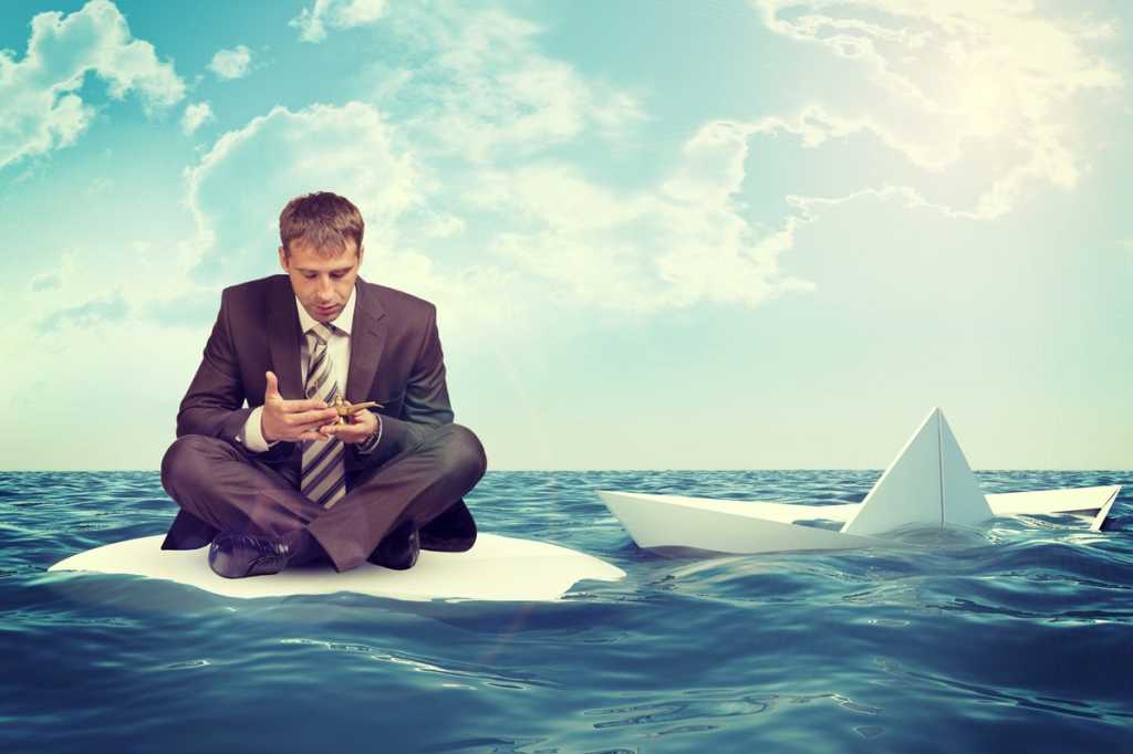 man floating on paper boat wishing genie in a bottle magic lamp lost