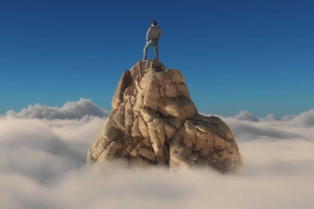 man on mountain top winner leader alone