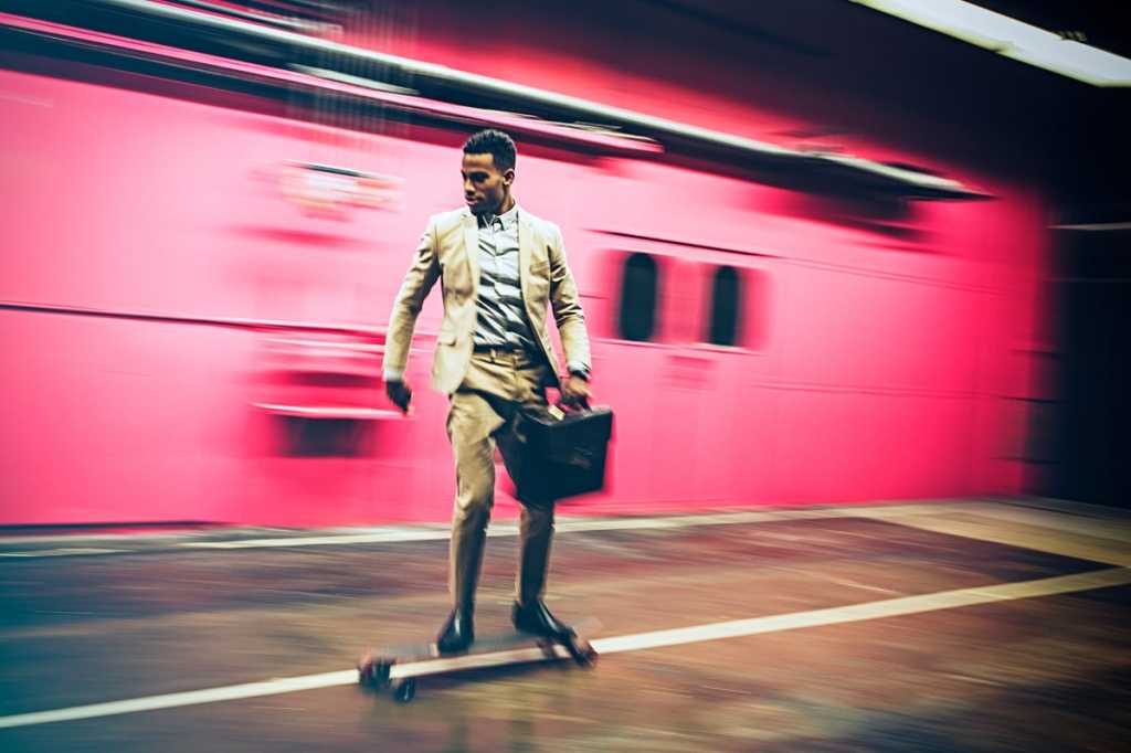 man skating on longboard speed responsive agile executive with briefcasse