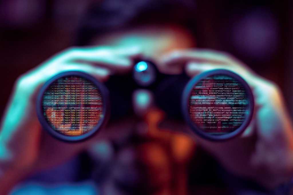 man with binoculars code binary cyber threat