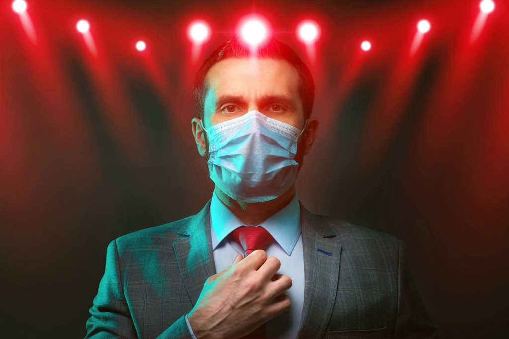 man in business suit wears a face mask post covid office workplaces by ivan kocha gettyimages 12205