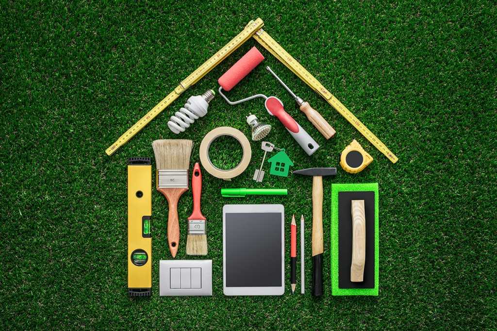 tools and a tablet forming the shape of a house/building