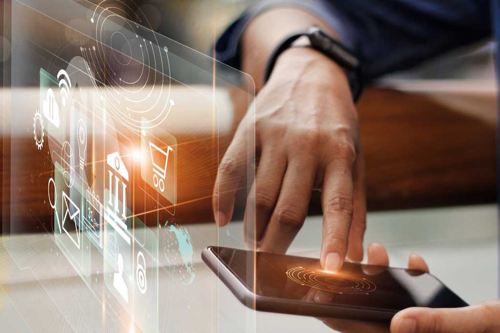 A mobile user manipulates a virtual display with finance-related icons.