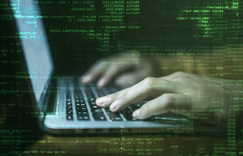 programmer hacker laptop with raining binary