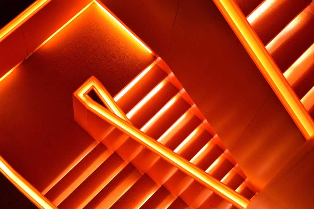 Aerial view of a glowing red staircase [movement/progress/descent/exit]
