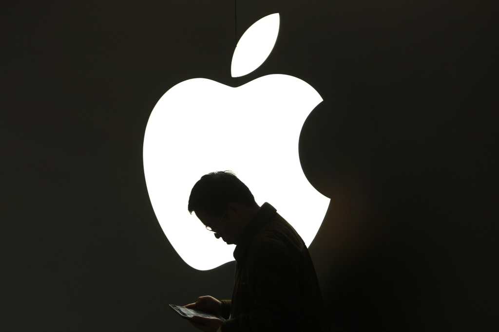 Apple logo with silhouette of man in front