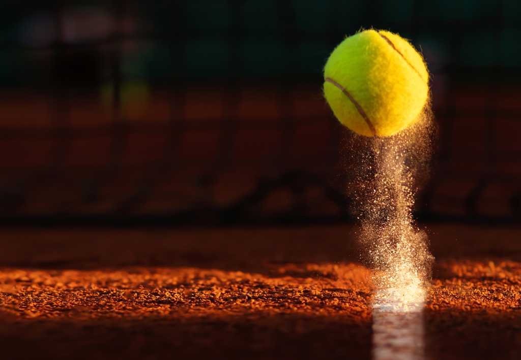 Tennis point. Tennis ball hitting the line for a point.