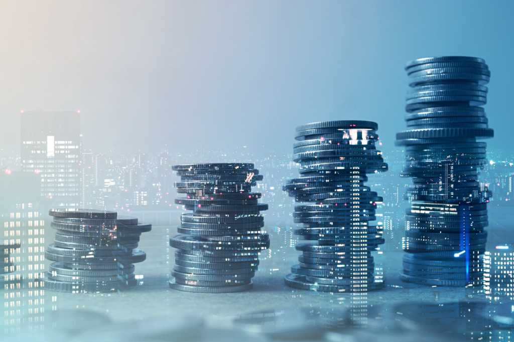 Double exposure of city and rows of coins for finance and banking concept