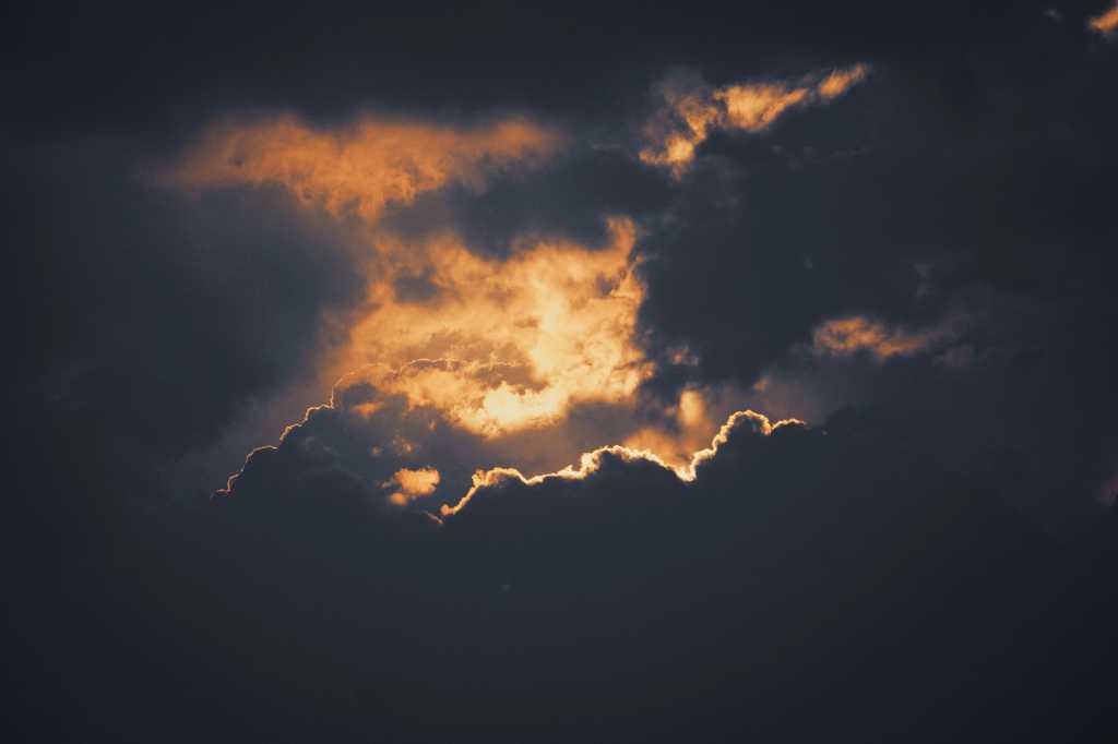A silver lining breaks through dark, stormy clouds.