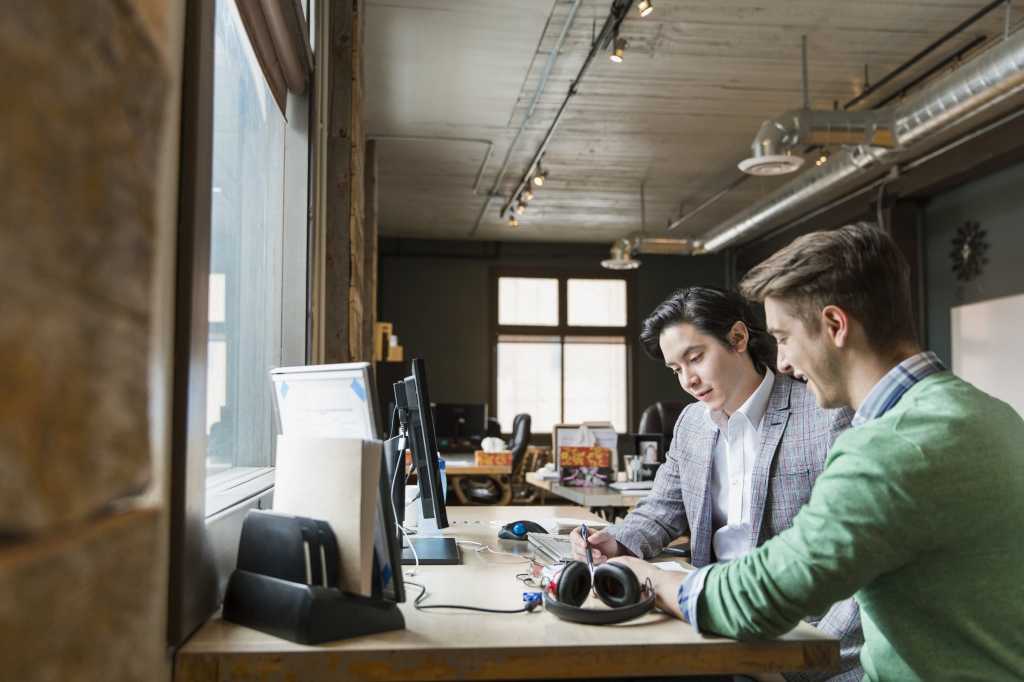 stock photo entrepreneurs working in creative office space 84041199