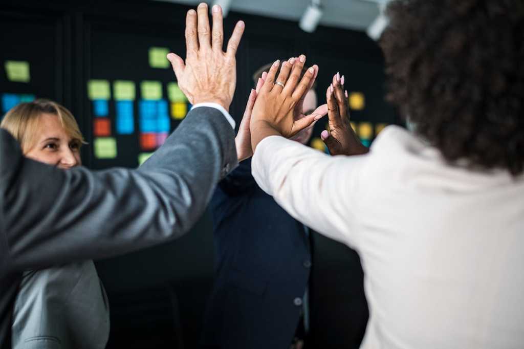 high five among a happy, collaborative group