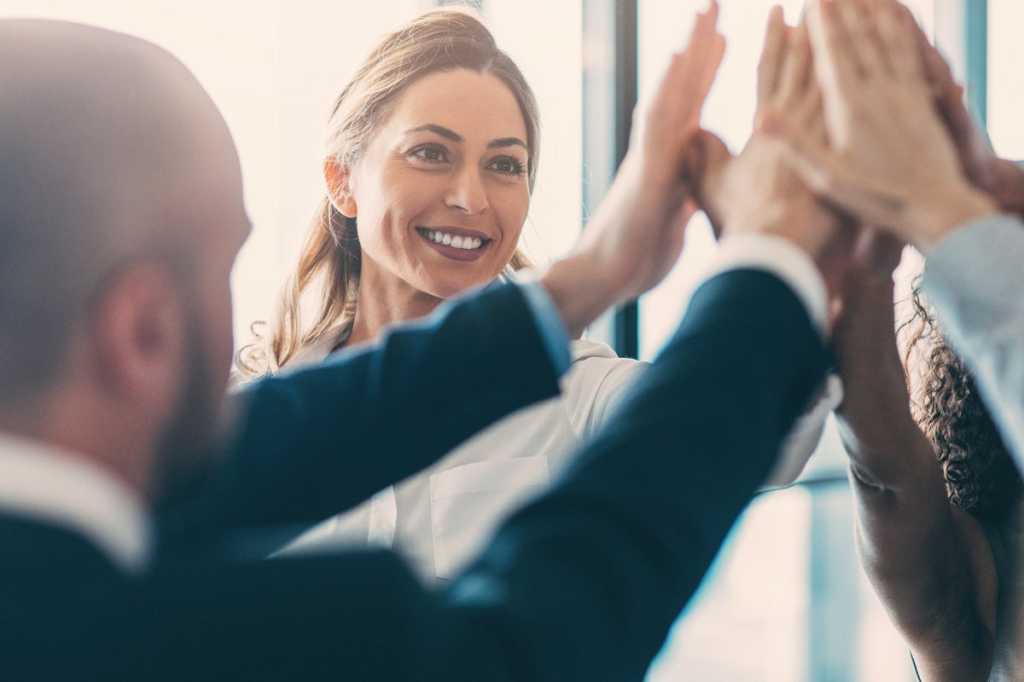 teamwork team building high five celebrate victory by iladendron getty