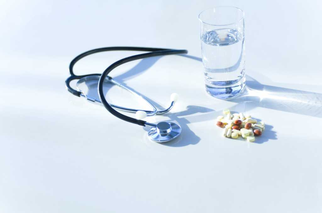 stethoscope with pills and healthcare items