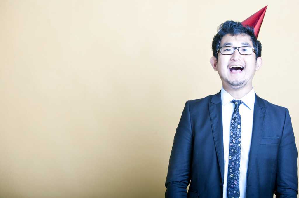 Happy man with red birthday hat