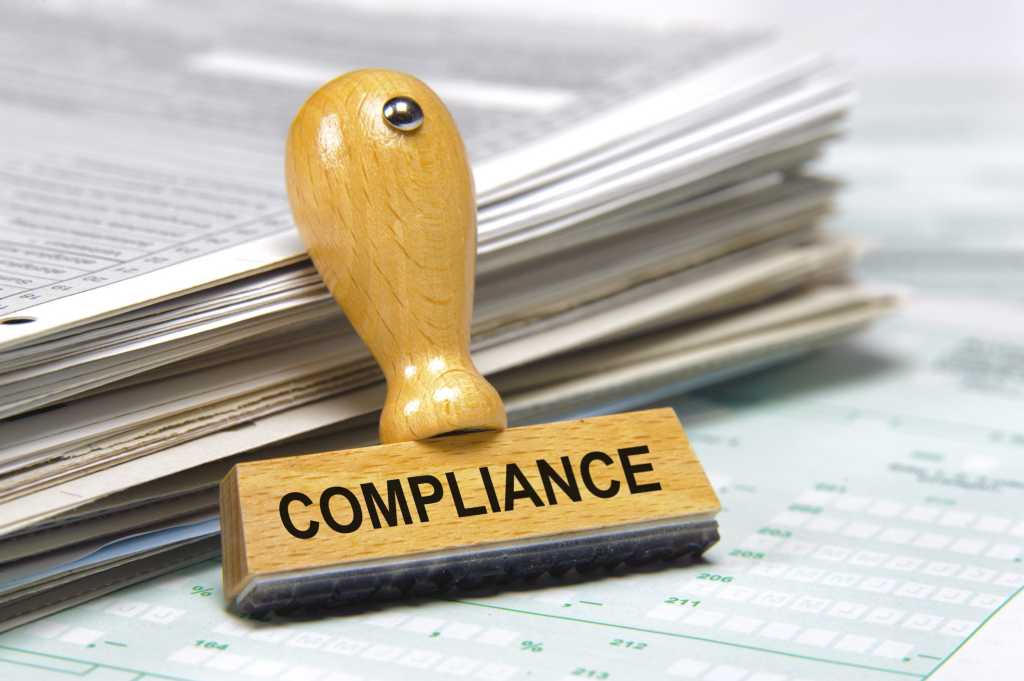 Stack of legal documents with compliance and regulatory stamp