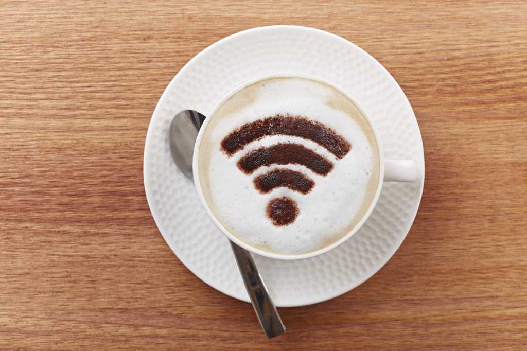 cup of coffee with wireless logo in foam