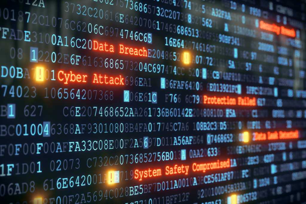 Cyber security breach attack on monitor with binary code