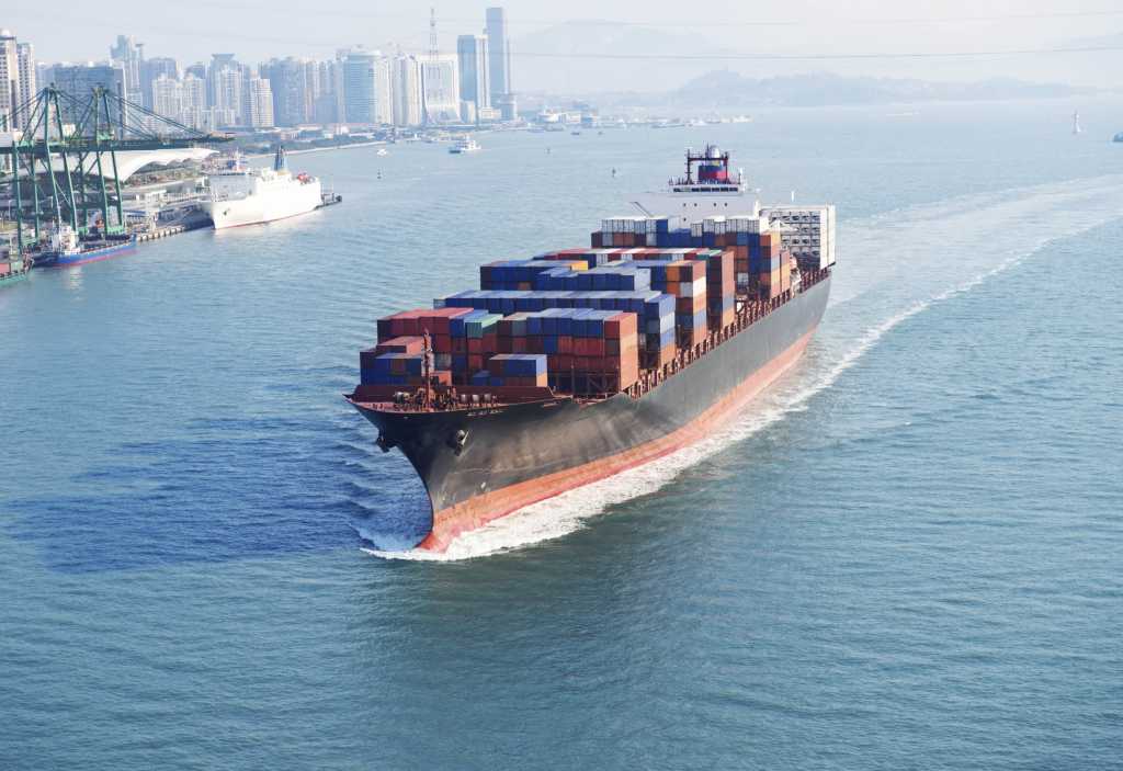 Cargo ship with shipping containers in ocean